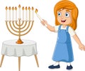 Happy jewish girl lights hanukkah candles Royalty Free Stock Photo