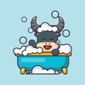 Cute buffalo taking bubble bath in bathtub.