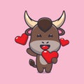 Cute bull cartoon character holding love heart in valentines day. Royalty Free Stock Photo