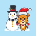 Cute leopard playing with Snowman. Cute christmas cartoon character illustration. Royalty Free Stock Photo