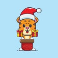 Cute leopard with santa hat in the chimney. Cute christmas cartoon character illustration. Royalty Free Stock Photo