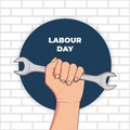 illustration of labour day celebration with hand grasping the wrench