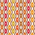 Mid century modern atomic starburst seamless pattern on ogee oval shapes in orange, red, brown, yellow and tangerine.