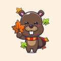 Cute beaver holding autumn leaf.