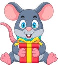 Cute mouse cartoon is sitting and holding a gift box. Royalty Free Stock Photo