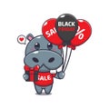 cute hippo with gifts and balloons in black friday sale cartoon vector illustration.