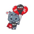 cute hippo with shopping bag and balloon at black friday sale cartoon vector illustration.