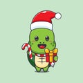 Cute turtle holding christmas candy and gift. Cute christmas cartoon character illustration. Royalty Free Stock Photo