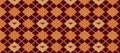 Geometric knit print featuring a repeating diamond pattern in brown, orange, and beige hue Royalty Free Stock Photo