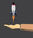 Illustration of a stylized rocket launching , rocket is predominantly white with blue fins Royalty Free Stock Photo