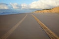 Print of car wheels on a ocean beach Royalty Free Stock Photo