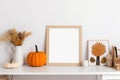 Print frame autumn mockup on shelf in living room