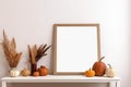 Print frame autumn mockup on table in living room