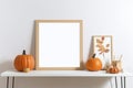 Print frame autumn mockup on table in living room