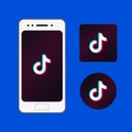 Set of TikTok logo. White smartphone with popular social media TikTok app icon on screen.