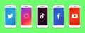 Set of white smartphones with popular social media logo on screen. Twitter, Instagram, TikTok, Facebook, Youtube app icons.