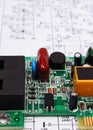 Printed circuit board lying on diagram of electronics, technology Royalty Free Stock Photo