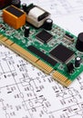 Printed circuit board lying on diagram of electronics, technology Royalty Free Stock Photo