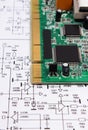 Printed circuit board lying on diagram of electronics, technology Royalty Free Stock Photo