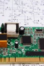 Printed circuit board lying on diagram of electronics, technology Royalty Free Stock Photo