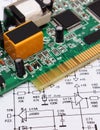 Printed circuit board lying on diagram of electronics, technology Royalty Free Stock Photo