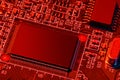 Printed circuit board and microchip, or cpu, in red light closeup - electronic component for digital equipment, concept for