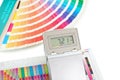 Printed color swatch with density meter and paint guide isolated on white background. Color density check in printing process.