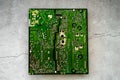 Printed green circuit board with electrical shot isolated on concrete background Royalty Free Stock Photo
