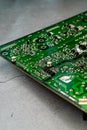 Printed green circuit board, isolated on concrete background Royalty Free Stock Photo
