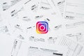 Printed Instagram logo on many tax form blanks lies on table close up. Help with tax problems using internet and information from