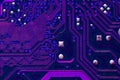 Printed neon purple circuit board. Electronic computer technology. Motherboard digital chip. Background of technical