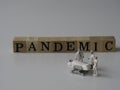 The printed pandemic incident is on the wooden blocks with white background. Royalty Free Stock Photo