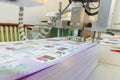 Printed sheets on folding machine into printing plant Royalty Free Stock Photo