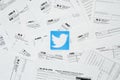 Printed Twitter logo on many tax form blanks lies on table close up. Help with tax problems using internet and information from