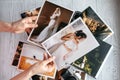 Printed wedding photos with the bride and groom, a vintage black camera and woman hands with two photos