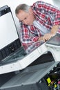 Printer checking print run at table Royalty Free Stock Photo