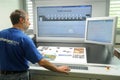 Printer checking a print run at table Royalty Free Stock Photo
