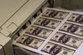 Printer printing fake dollar bills isolated on white