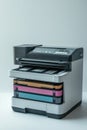 Printer sitting on top of stacked colored papers, great for office or study theme illustrations Royalty Free Stock Photo