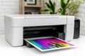 A printer sitting on a white table, ready for use Royalty Free Stock Photo