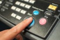 Printing machine control panel with start buttons. Worker`s hand, finger pushing the power button. Royalty Free Stock Photo