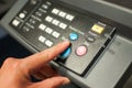 Printing machine control panel with start buttons. Worker`s hand, finger pushing the power button. Royalty Free Stock Photo