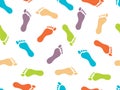 The prints of bare feet on white background. Seamless pattern. Bright color picture. Vector illustration