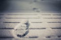 Prints in the snow from boots on deck Royalty Free Stock Photo