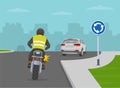 Priority inside the roundabout. Biker turned on blinker while approaching roundabout. Royalty Free Stock Photo