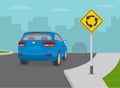 Priority inside the roundabout. Blue suv entering the roundabout. Back view.