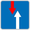 Priority over oncoming vehicles traffic sign isolated on blue.