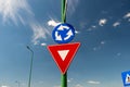 Priority street sign , roundabout against beautiful blue sky Royalty Free Stock Photo