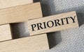 PRIORITY- word on a wooden bar on a gray background Royalty Free Stock Photo