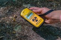 PRIPYAT, UKRAINE, AUGUST 30, 2019: Male hand holding a geiger counter at Chernobyl Exclusion zone in the Ukraine